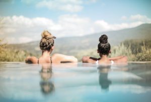two women's head and shoulders showing in a pool